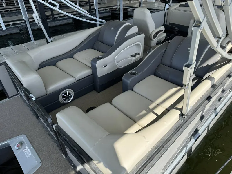 Slide: The Image of 2015 Premier 270 Grand Isle SL pontoon boat interior with plush seating and cup holders. - 10