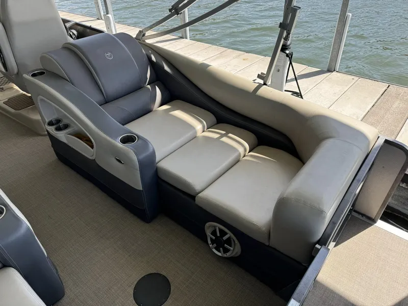 Slide: The Image of Luxurious seating on 2015 Premier 270 Grand Isle SL boat, docked by the water. - 11
