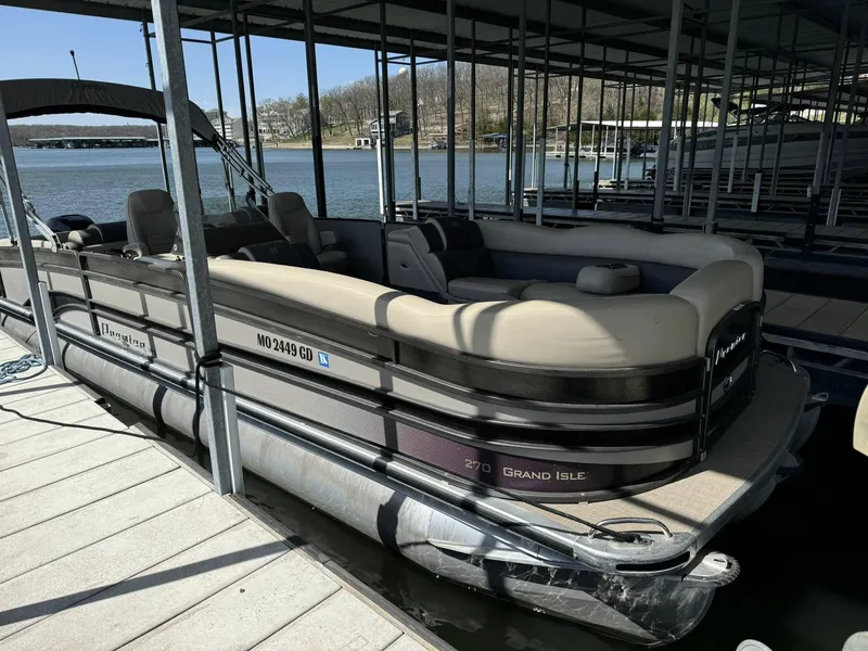 Slide: The Image of 2015 Premier 270 Grand Isle SL pontoon boat docked at a marina. - 12