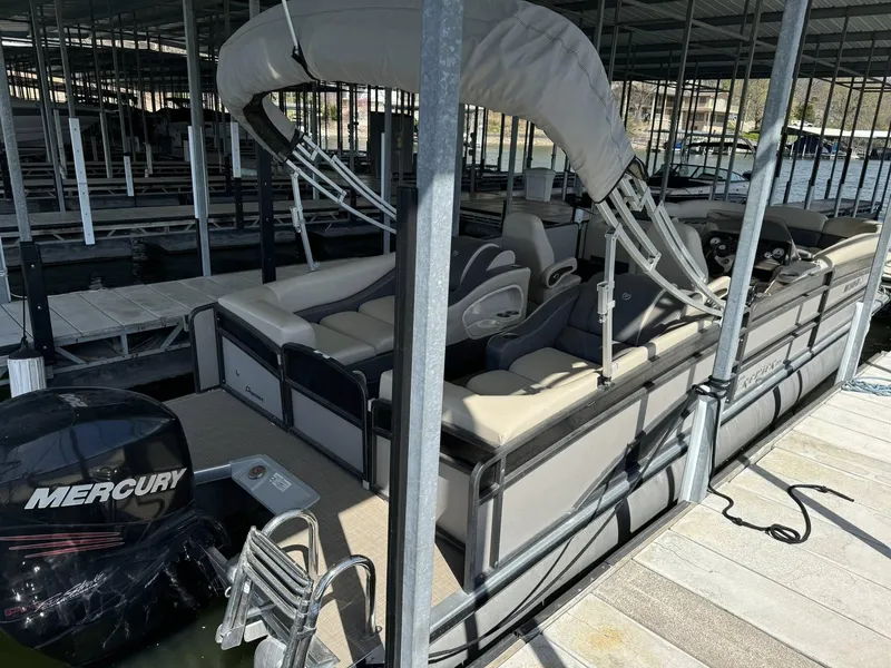 Slide: The Image of 2015 Premier 270 Grand Isle SL pontoon boat docked with Mercury outboard engine. - 3