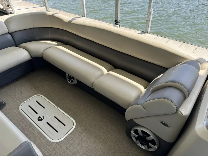Slide: The Image of Luxurious seating on 2015 Premier 270 Grand Isle SL pontoon boat by the water. - 6
