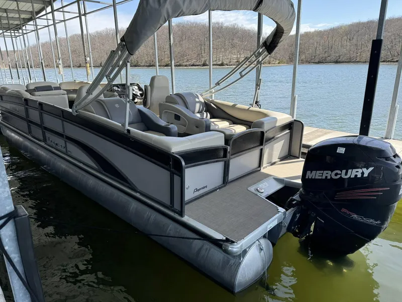Slide: The Image of 2015 Premier 270 Grand Isle SL pontoon boat with Mercury engine docked on a lake. - 7