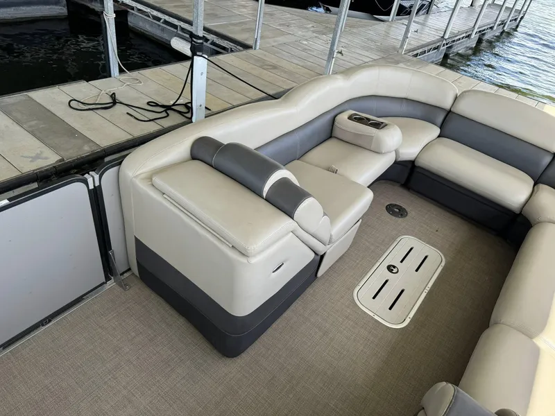 Slide: The Image of 2015 Premier 270 Grand Isle SL boat interior with beige seating and cup holders. - 8