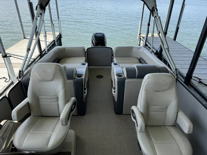 Slide: The Image of 2015 Premier 270 Grand Isle SL pontoon boat interior with plush seating and lake view. - 9