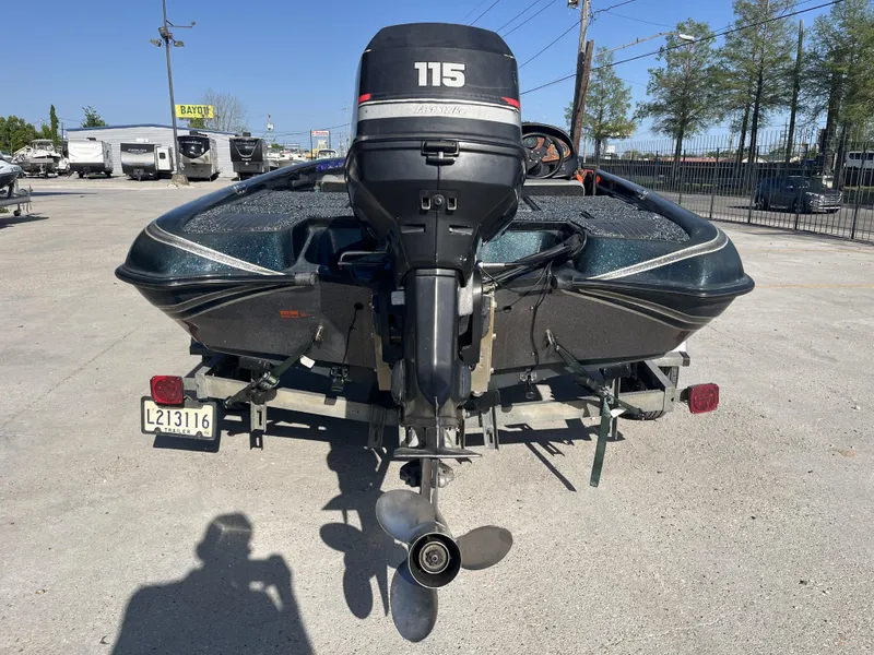 Slide: The Image of 1998 Triton Tr-17 boat with 115 horsepower engine, parked on a trailer in a lot. - 4