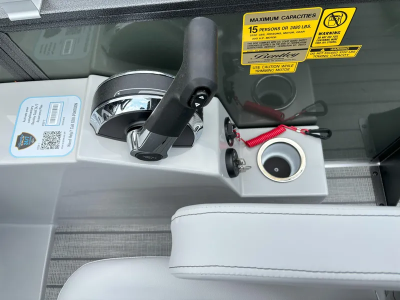 Slide: The Image of Control panel of 2025 Bentley Pontoons Legacy 223 Swingback with throttle and safety features. - 10