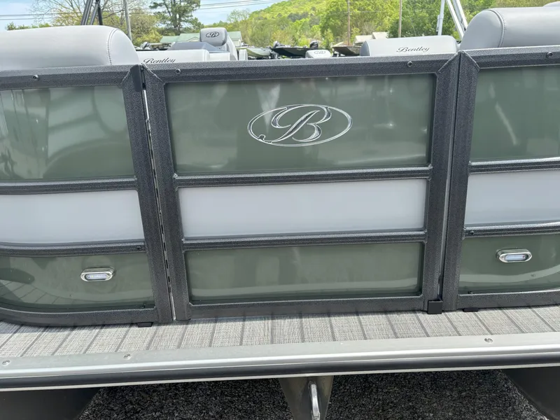 Slide: The Image of 2025 Bentley Pontoons Legacy 223 Swingback, rear view with logo and seating details. - 18