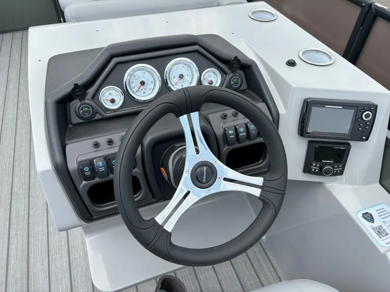 Slide: The Image of Steering console of 2025 Bentley Pontoons Legacy 223 Swingback with gauges and controls. - 9