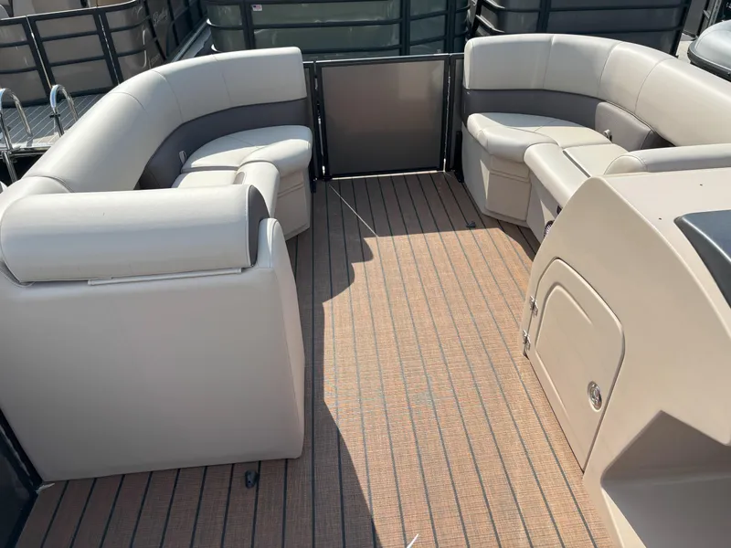 Slide: The Image of 2025 Bentley Pontoons Legacy 223 Swingback interior with beige seating and wood-patterned flooring. - 14