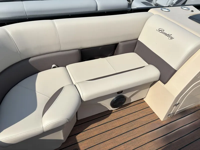 Slide: The Image of 2025 Bentley Pontoons Legacy 223 Swingback interior with beige seating and wood flooring. - 15