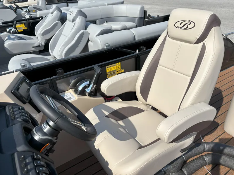 Slide: The Image of 2025 Bentley Pontoons Legacy 223 Swingback interior with luxurious captain's chair and steering wheel. - 18