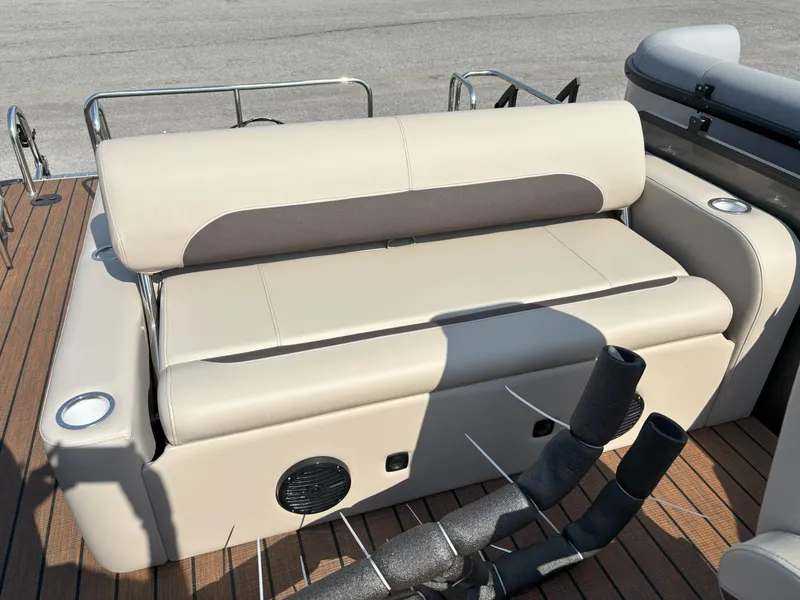 Slide: The Image of 2025 Bentley Pontoons Legacy 223 Swingback interior seating with beige upholstery and cup holders. - 19