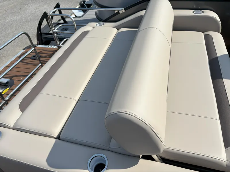 Slide: The Image of 2025 Bentley Pontoons Legacy 223 Swingback seating with beige upholstery and cup holders. - 21