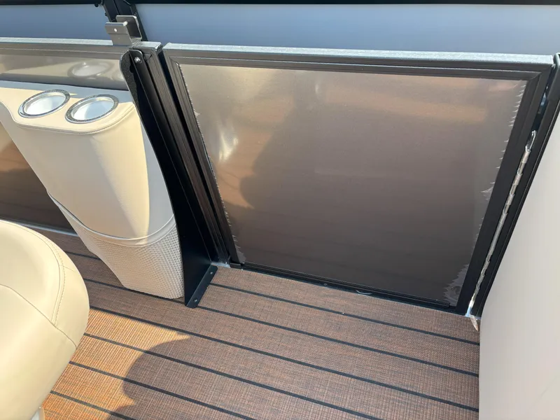 Slide: The Image of 2025 Bentley Pontoons Legacy 223 Swingback interior with cup holders and sleek design. - 5