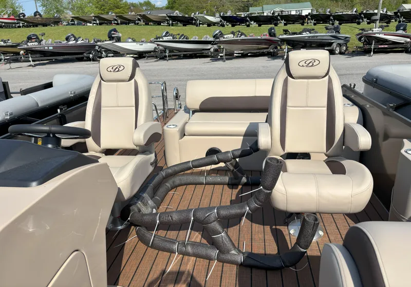 Slide: The Image of 2025 Bentley Pontoons Legacy 223 Swingback interior with plush seating and steering wheel. - 6