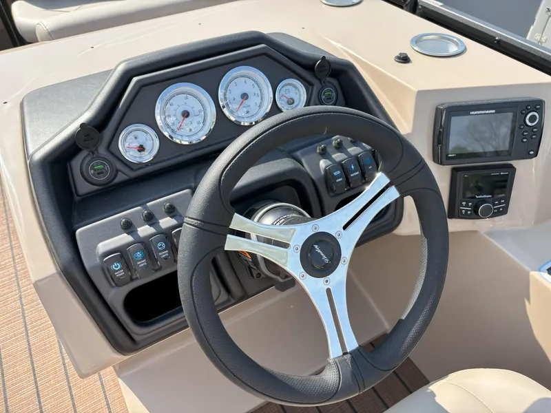 Slide: The Image of 2025 Bentley Pontoons Legacy 223 Swingback dashboard with steering wheel and control panel. - 8