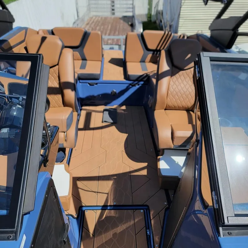 Slide: The Image of 2024 Yamaha Boats 222XD interior with tan leather seats and blue accents. - 3