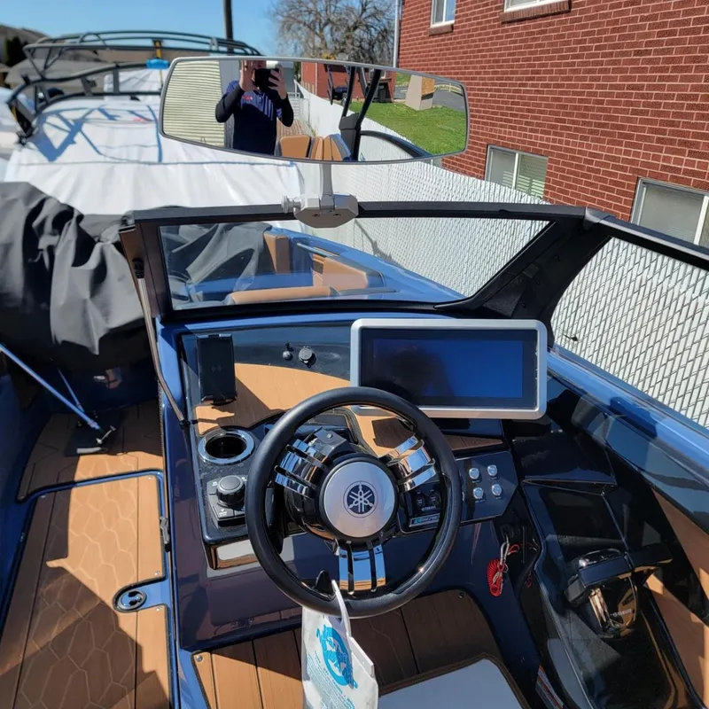 Slide: The Image of 2024 Yamaha Boats 222XD dashboard with steering wheel and touchscreen display. - 6