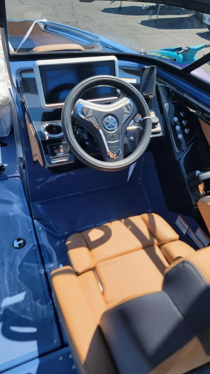 Slide: The Image of 2024 Yamaha Boats 222XD cockpit with modern steering wheel and dashboard controls. - 7