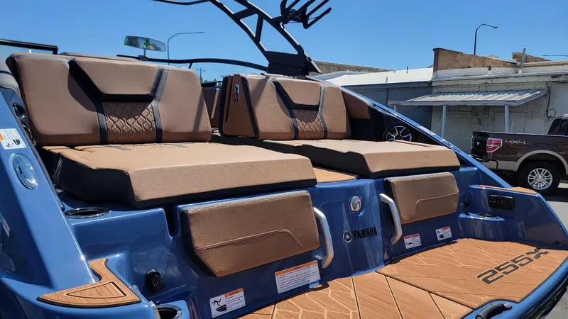 Slide: The Image of 2024 Yamaha Boats 222XD interior with brown seating and blue accents. - 8