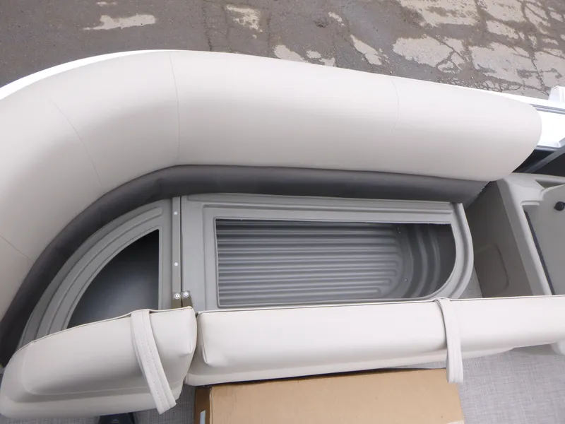 Slide: The Image of 2025 Sun Tracker Party Barge 16 DLX seating area with storage compartment. - 11
