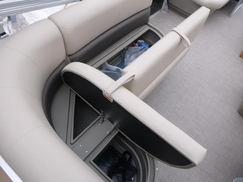 Slide: The Image of 2025 Sun Tracker Party Barge 16 DLX interior with open storage compartment. - 8