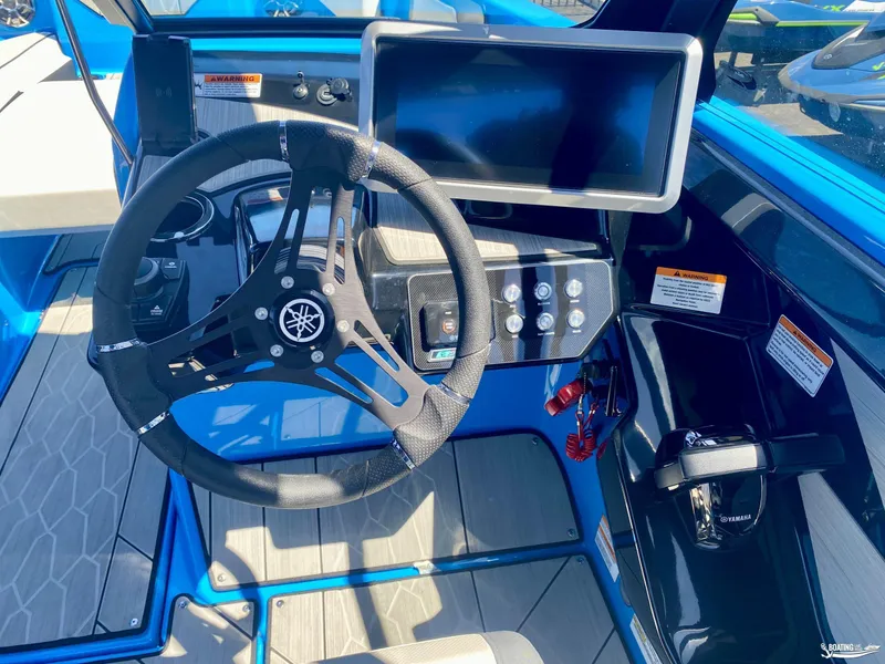 Slide: The Image of 2023 Yamaha Boats 222XE cockpit with steering wheel and control panel, featuring modern design. - 9