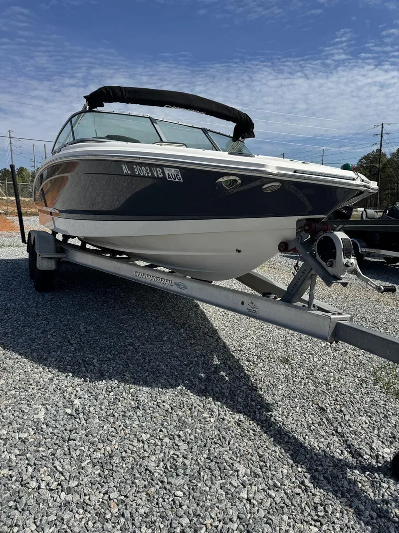 Slide: The Image of 2014 Chaparral 206 SSi boat on trailer, parked on gravel under a clear sky. - 3