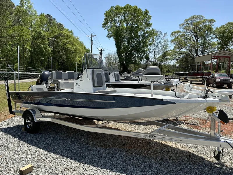 Slide: The Image of 2025 Xpress Hyper-Lift Series H20B boat with new console on a trailer, outdoors. - 1