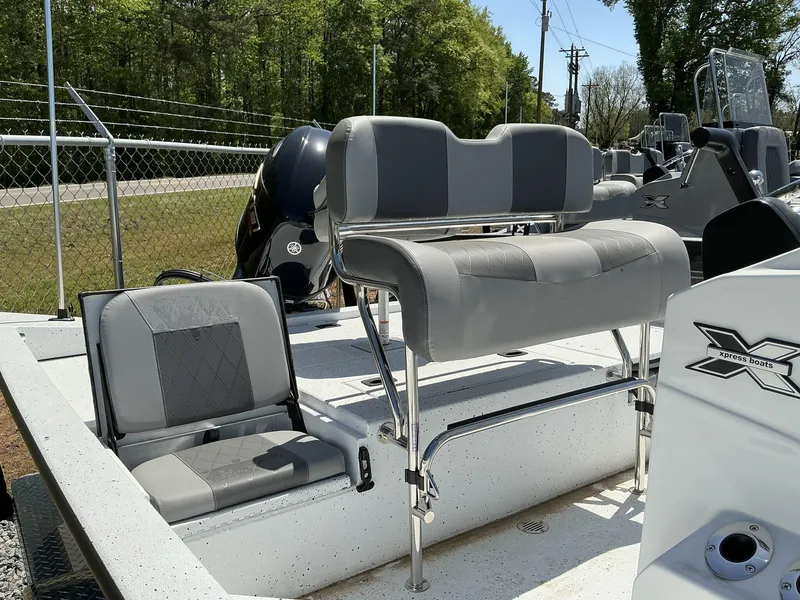 Slide: The Image of 2025 Xpress Hyper-Lift Series H20B boat with new console and seating, outdoors. - 2