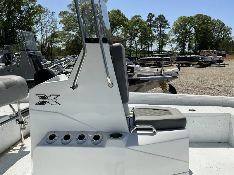 Slide: The Image of 2025 Xpress Hyper-Lift Series H20B boat console with seating, in a sunny outdoor setting. - 4