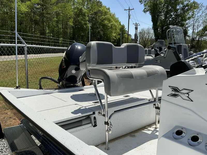 Slide: The Image of 2025 Xpress Hyper-Lift Series H20B boat with new console and seating, outdoors. - 5