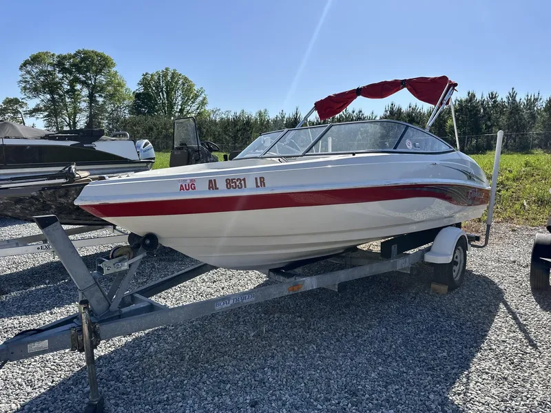 Slide: The Image of 2007 Caravelle 182 186 Model boat on trailer, red and white design, parked outdoors. - 1