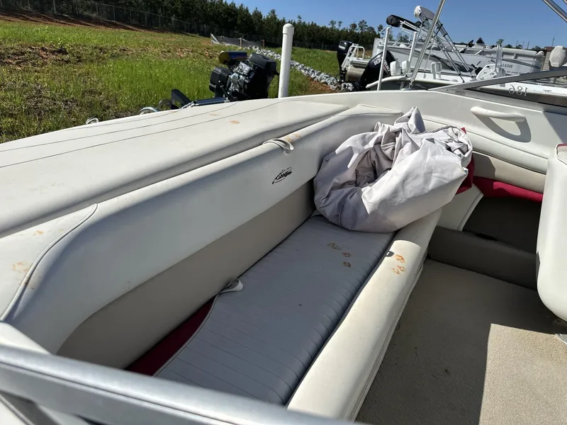 Slide: The Image of Interior of a 2007 Caravelle 182 186 boat with white seating and a cover. - 10