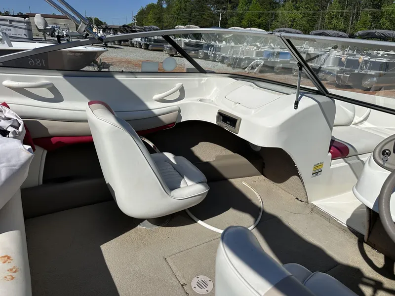 Slide: The Image of Interior of a 2007 Caravelle 182 186 MODEL boat with white seating and dashboard. - 6