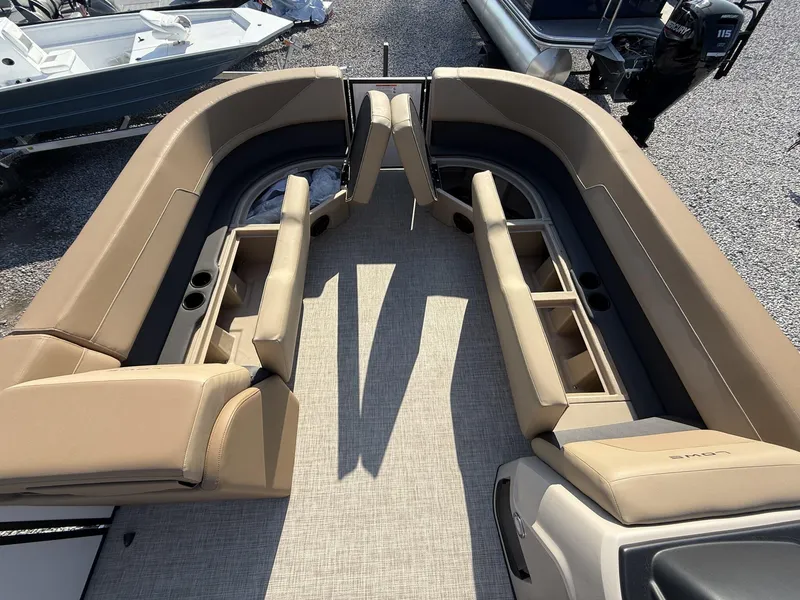 Slide: The Image of Luxurious seating on 2025 Lowe LS 210 boat, featuring tan upholstery and ample storage. - 4