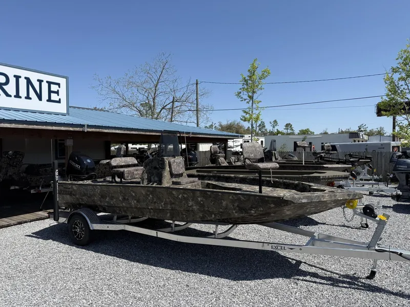 Slide: The Image of 2025 Excel Bay Pro 203 Elite boat on trailer at marine dealership. - 1