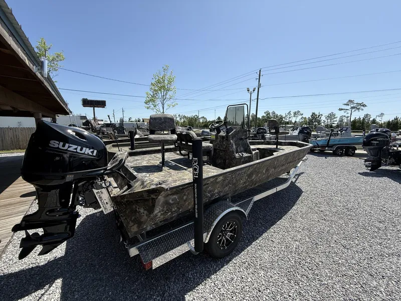 Slide: The Image of 2025 Excel Bay Pro 203 Elite boat with Suzuki outboard motor on trailer. - 2