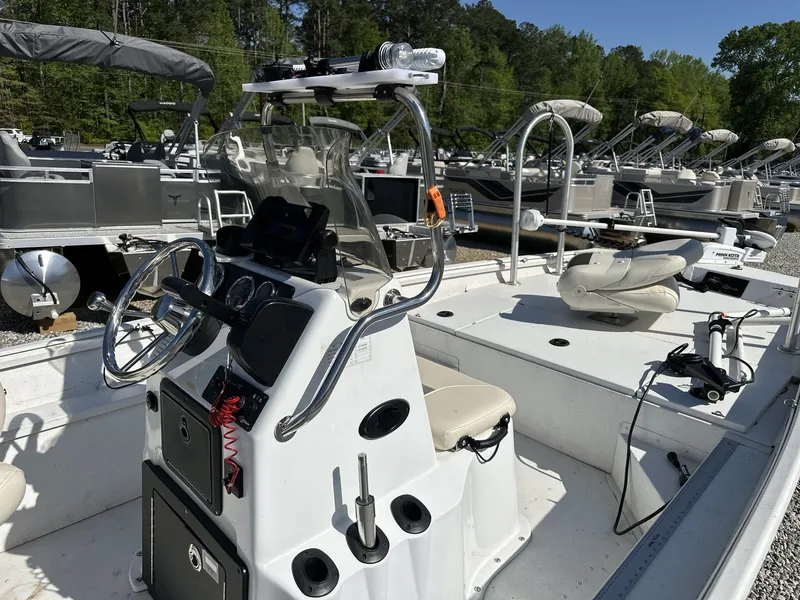 Slide: The Image of 2022 G3 Bay 17 BAY boat interior with steering console and seating, docked outdoors. - 6