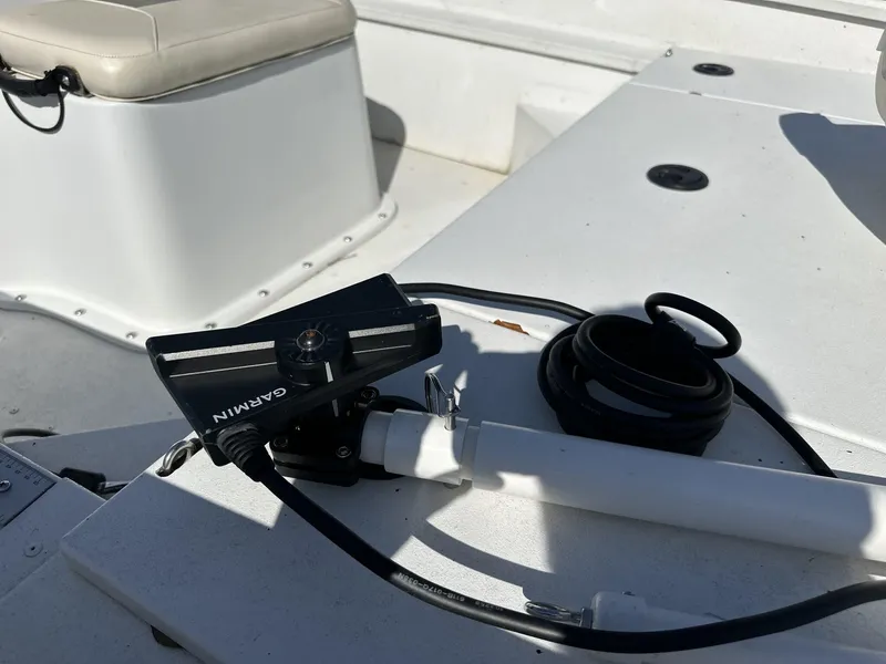 Slide: The Image of Garmin device on 2022 G3 Bay 17 BAY boat deck, with coiled cable and seating. - 8