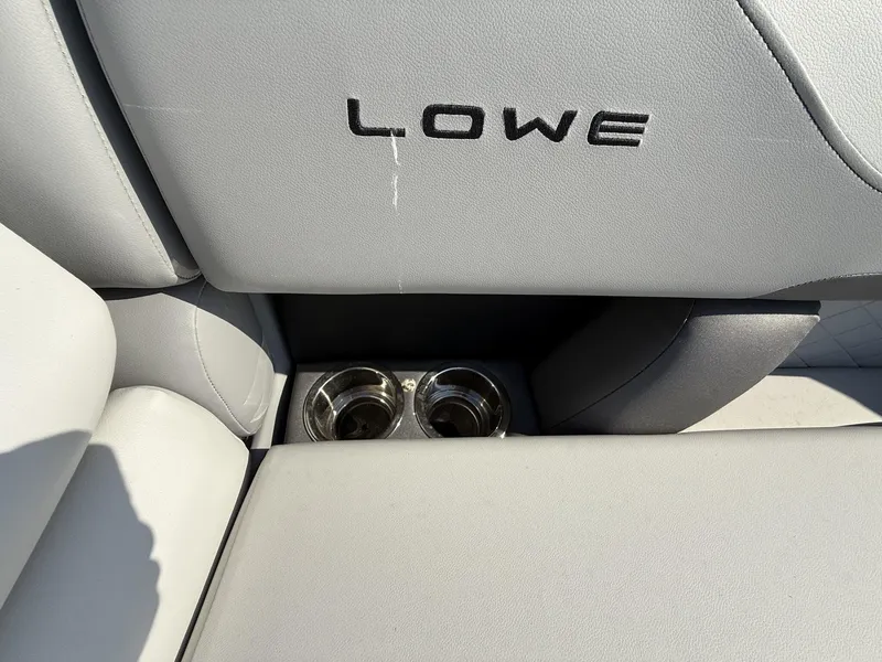 Slide: The Image of Lowe SS230 2025 boat interior with cup holders and logo detail. - 4