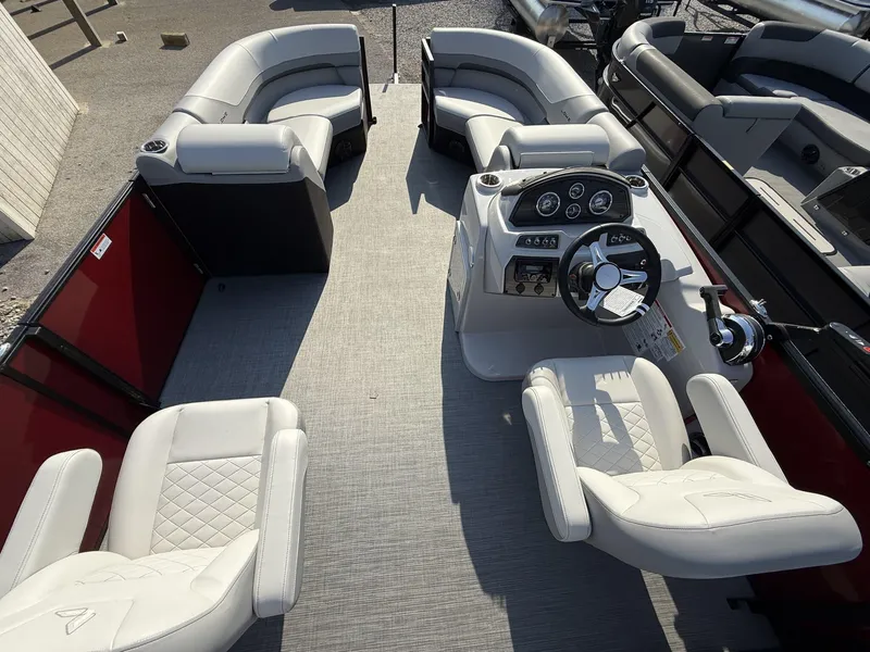 Slide: The Image of 2025 Lowe SS230 pontoon boat interior with plush seating and modern dashboard. - 6
