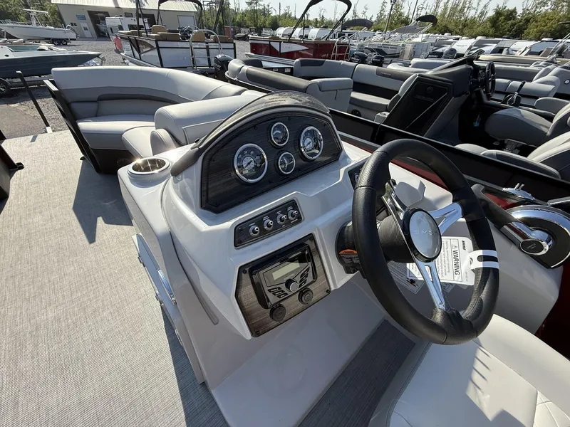 Slide: The Image of 2025 Lowe SS230 boat dashboard with steering wheel and control panel. - 7