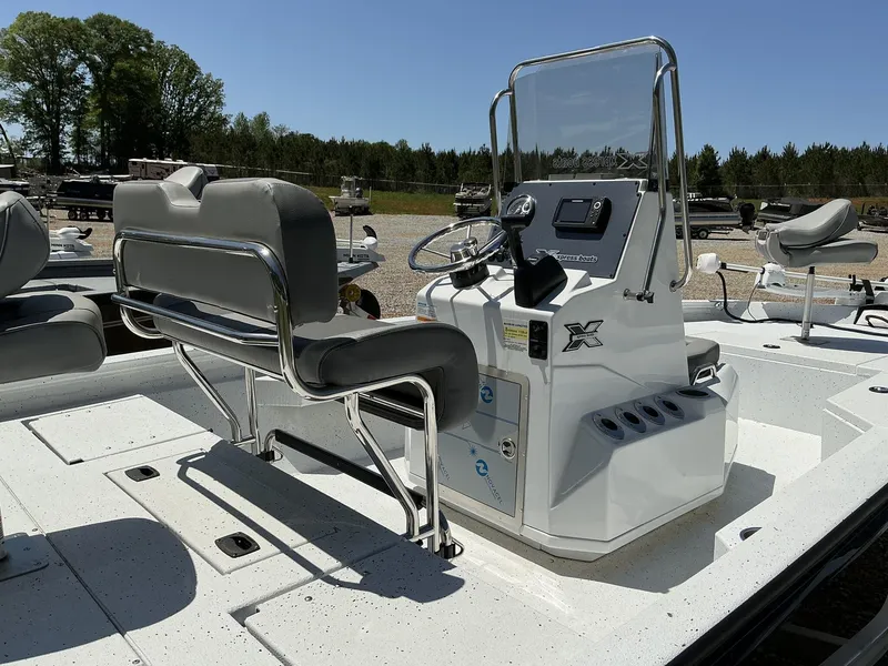 Slide: The Image of 2025 Xpress Hyper-Lift Series H20B boat console with seating, steering, and controls. - 6