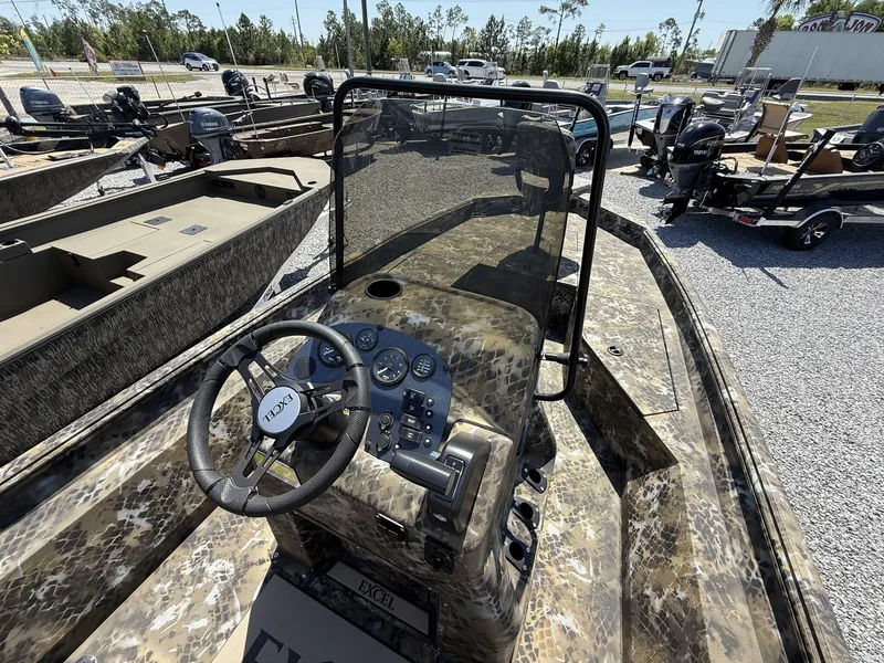 Slide: The Image of 2025 Excel Bay Pro 203 Elite boat interior with camouflage design and steering console. - 4