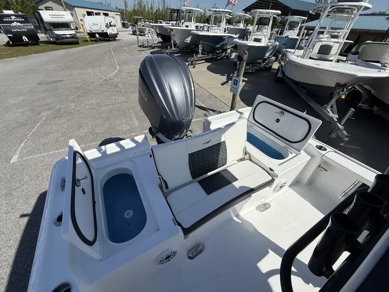 Slide: The Image of 2025 Tidewater 2410 Bay Max boat interior with seating and storage compartments. - 15