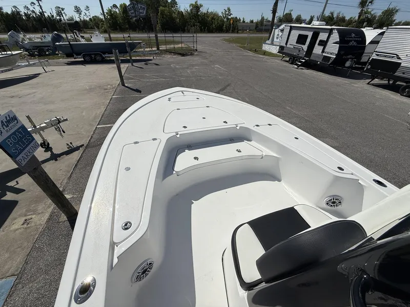 Slide: The Image of 2025 Tidewater 2410 Bay Max boat interior at a sales lot with trailers in background. - 4