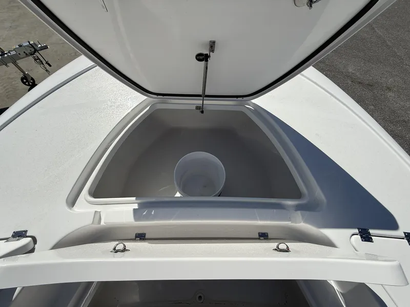 Slide: The Image of Open storage compartment on 2025 Tidewater 2410 Bay Max boat, featuring a white interior. - 9