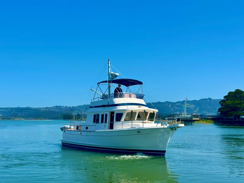 Slide: The Image of 2006 Selene Archer 36 yacht cruising on a serene lake under a clear blue sky. - 1