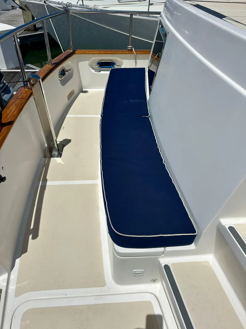 Slide: The Image of Selene Archer 36 yacht deck with blue cushioned seating, 2006 model. - 10